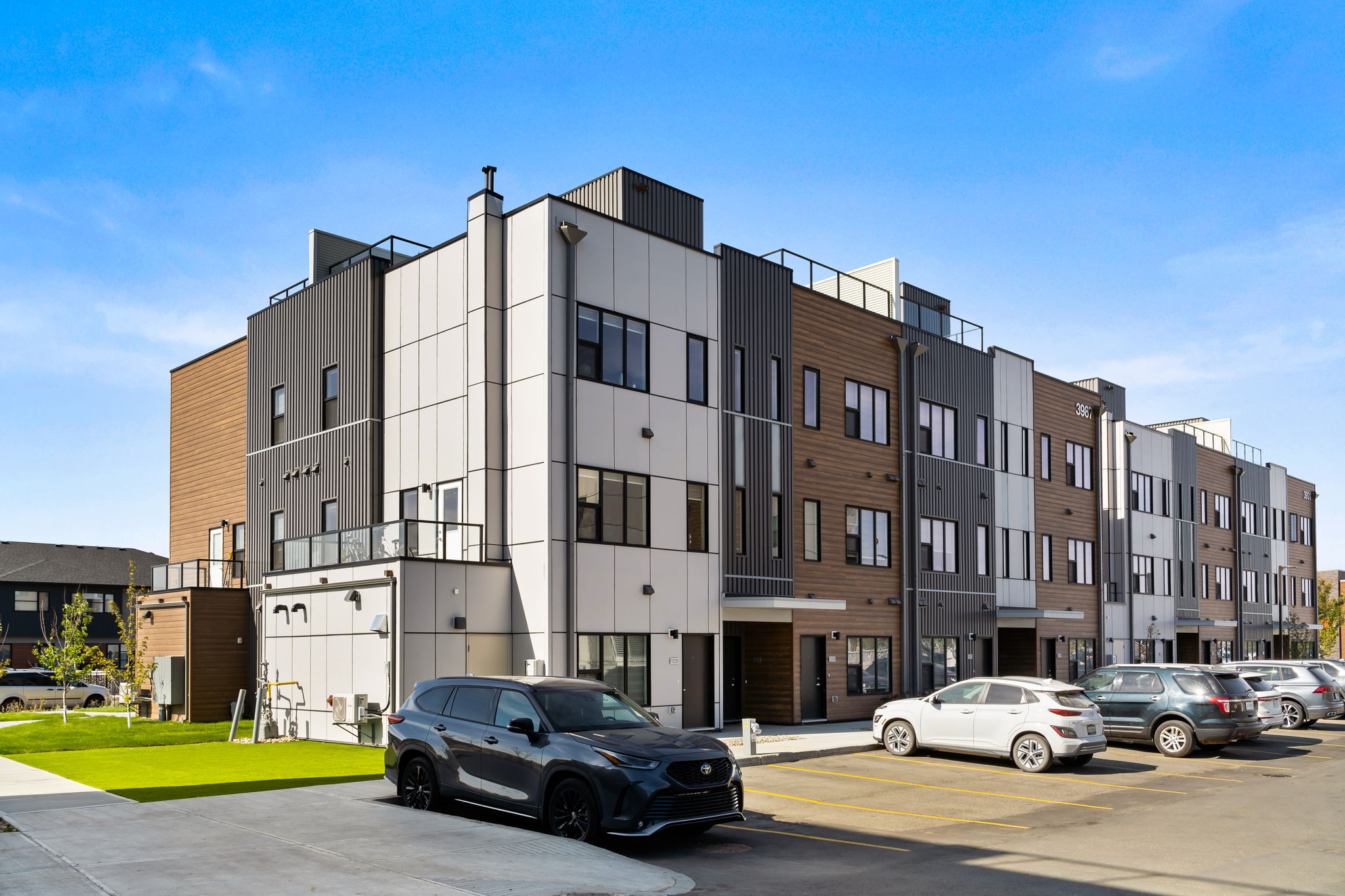 Image of the back of the building, showing the parking lot area and green space nearby.