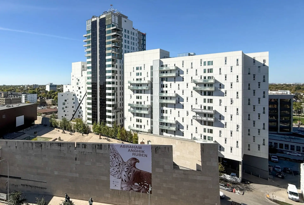 A photograph of the Solara Flats residence with the Winnipeg Art Gallery in the foreground.